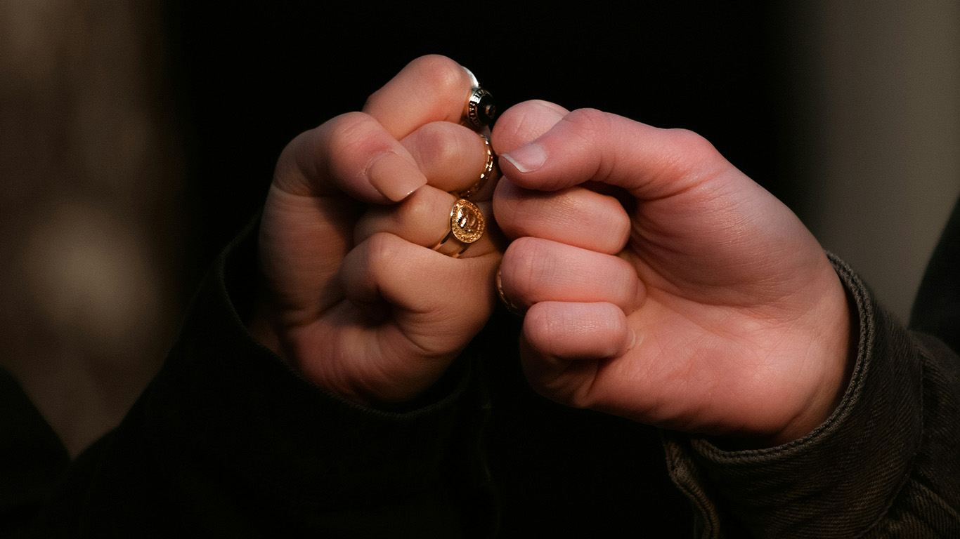 Two women giving a fist bump to one another as a way to represent friends helping friends.